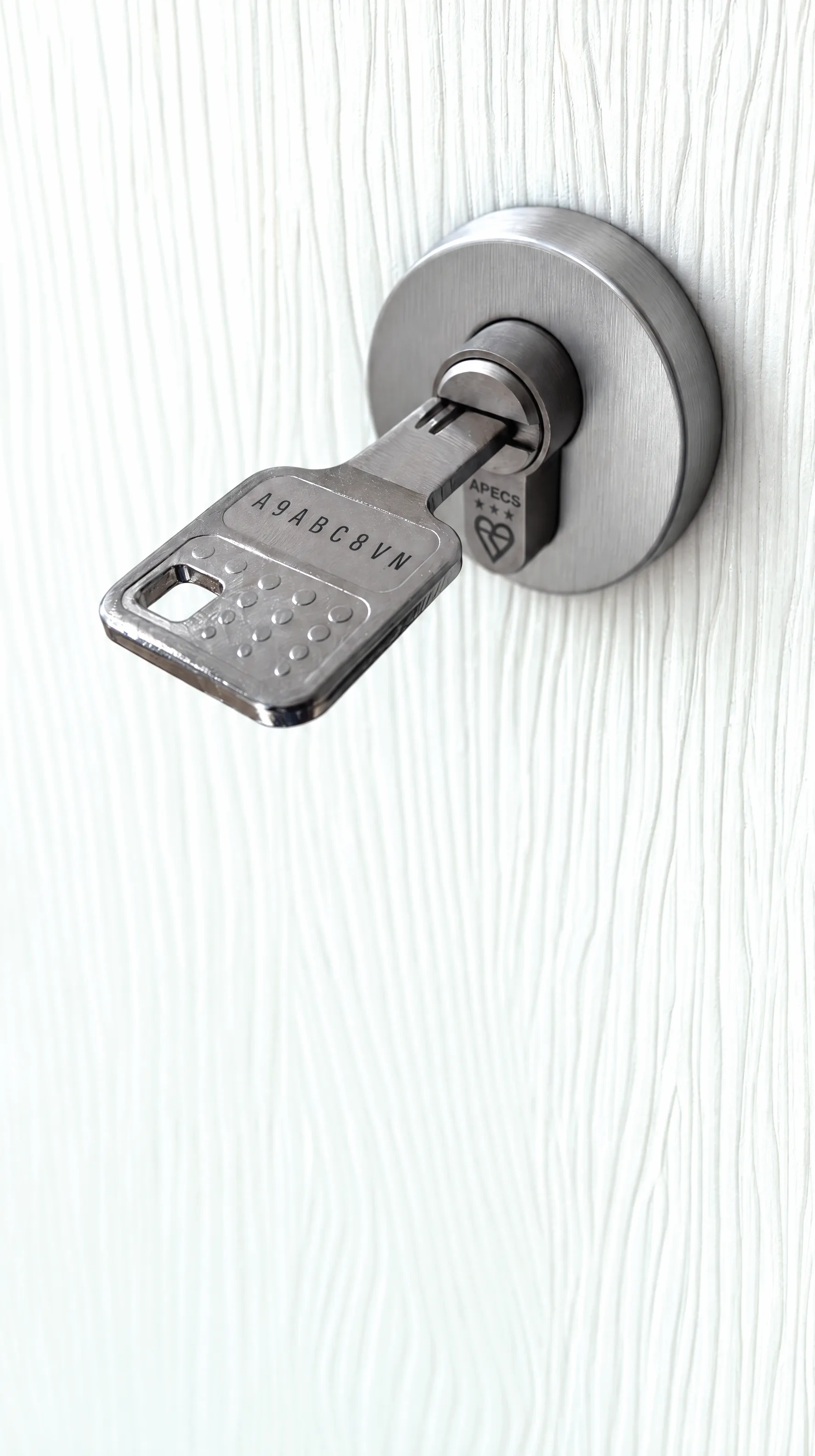 Three-star cylinder and key on a white Clearwater door